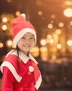 Portrait of beautiful girl wearing Santa Claus hat .