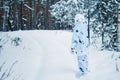 Portrait of a beautiful girl in white camouflage hunter with a g