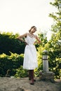 Portrait of a beautiful girl in a white dress in the garden. Burnette beautiful natural girl with in a white dress in