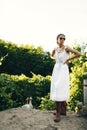 Portrait of a beautiful girl in a white dress in the garden. Burnette beautiful natural girl with in a white dress in
