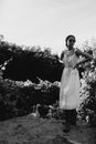 Portrait of a beautiful girl in a white dress in the garden. Burnette beautiful natural girl with in a white dress in