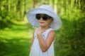 Portrait of a beautiful girl in a white hat summer day in the park Royalty Free Stock Photo