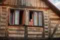 Portrait of beautiful girl at the window frame of wooden, forest house. Young teen girl in the window of a wooden house Royalty Free Stock Photo