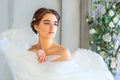 Portrait of a beautiful girl wrapped in white angel wings Royalty Free Stock Photo