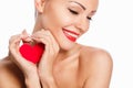 Portrait of Beautiful gorgeous smiling woman with glamour bright makeup and red heart in hand