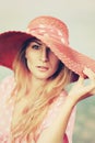 Portrait of a beautiful graceful woman in elegant pink hat with a wide brim. Beauty, fashion concept. Looking in the Royalty Free Stock Photo