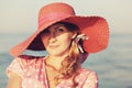 Portrait of a beautiful graceful woman in elegant pink hat with a wide brim. Beauty, fashion concept. Looking in the Royalty Free Stock Photo