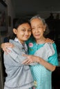 Portrait of Beautiful Grandmother and Teenage Granddaughter Hugging and Smiling Happy to See Each Other Royalty Free Stock Photo