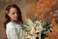 beautiful happy bride holding wedding autumn bouquet