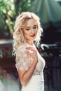 Portrait of Beautiful Happy Curly Blond Hair Bride. Fashion Dress and MakeUp with Red Lips Royalty Free Stock Photo