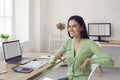 Portrait of beautiful happy female accountant sitting at her workplace in office. Royalty Free Stock Photo