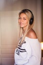 Portrait of beautiful happy girl with headphones listening to pop music. Royalty Free Stock Photo