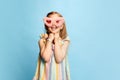 Portrait of beautiful, happy, little girl, child posing in pink furry glasses, smiling against blue studio background Royalty Free Stock Photo