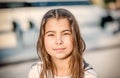 Portrait of a beautiful happy little girl smiling and looking at Royalty Free Stock Photo