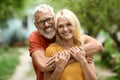 Portrait Of Beautiful Happy Senior Couple Posing Outdoors In Garden Royalty Free Stock Photo