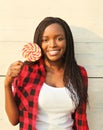 Portrait beautiful happy smiling african woman with sweet lollipop Royalty Free Stock Photo