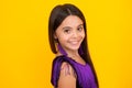 Portrait of beautiful happy smiling teenage girl on yellow studio background. Royalty Free Stock Photo