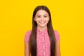 Portrait of beautiful happy smiling teenage girl on yellow studio background. Royalty Free Stock Photo