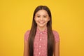 Portrait of beautiful happy smiling teenage girl on yellow studio background. Royalty Free Stock Photo