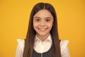 Portrait of beautiful happy smiling teenage girl on yellow studio background. Royalty Free Stock Photo