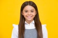 Portrait of beautiful happy smiling teenage girl on yellow studio background. Happy girl face, positive and smiling Royalty Free Stock Photo