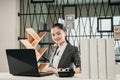 Portrait of beautiful happy smiling young woman employe sitting at office desk with laptop Royalty Free Stock Photo