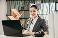Portrait of beautiful happy smiling young woman employe sitting at office desk with laptop Royalty Free Stock Photo