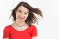 Portrait of a beautiful happy smiling young woman wearing red t-shirt wind blows her hair, background, studio shoot Royalty Free Stock Photo