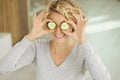 portrait beautiful happy woman with cucumbers to eyes at home Royalty Free Stock Photo