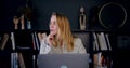 Portrait of beautiful happy young blonde Caucasian creative writer woman using laptop, thinking of ideas slow motion. Royalty Free Stock Photo