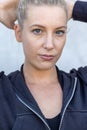 Portrait of beautiful, healthy, strong and fit young caucasian woman wearing a black hoodie flexing both arms muscles on Royalty Free Stock Photo