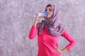 beautiful hijab sporty woman drinking mineral water after workou Royalty Free Stock Photo