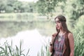 Beautiful hippie girl on the background of a forest lake Royalty Free Stock Photo