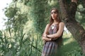 Beautiful hippie girl standing among trees in forest Royalty Free Stock Photo