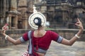 Indian Classical odissi dancer wears traditional costume and posing in front of Mukteshvara Temple,Bhubaneswar, Odisha, India