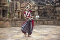 Indian classical odissi dancer wears traditional costume and posing in front of Mukteshvara Temple,Bhubaneswar, Odisha, India