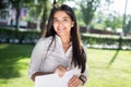 Portrait of a beautiful indian girl. Business woman smiling holding business papers in her hands. Outdoors Royalty Free Stock Photo