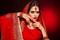 Portrait of beautiful indian girl in red bridal sari. Young hindu woman model with kundan jewelry set. Traditional Indian costume Royalty Free Stock Photo