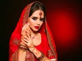 Portrait of beautiful indian girl in red bridal sari. Young hindu woman model with kundan jewelry set. Traditional Indian costume Royalty Free Stock Photo