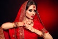 Portrait of beautiful indian girl in red bridal sari. Young hindu woman model with kundan jewelry set. Traditional Indian costume Royalty Free Stock Photo