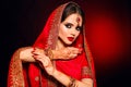 Portrait of beautiful indian girl in red bridal sari. Young hindu woman model with kundan jewelry set. Traditional Indian costume Royalty Free Stock Photo