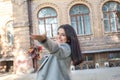 Portrait of a beautiful Indian girl, smiling spinning, dancing with autumn leaves in her hand