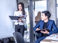 Portrait of beautiful intern standing at office in front of flip chart and presenting in the meeting room Royalty Free Stock Photo