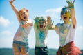 Portrait of a beautiful kids showing colorful colored hands. Happy childhood. Emotional cheerful excited children.