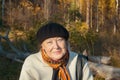 Portrait of beautiful kind senior woman in autumn park