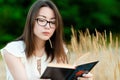 Portrait beautiful korean girl reading book outdoors Royalty Free Stock Photo
