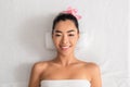 Portrait Of Beautiful Korean Woman With Flower In Hair Lying At Spa Royalty Free Stock Photo