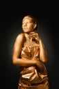 Portrait of beautiful lady with gold paint on skin