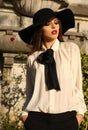 Portrait of beautiful ladylike woman wearing elegant blouse and hat Royalty Free Stock Photo