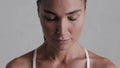 Close up face of determined latin woman breathing deeply before fitness exercise.